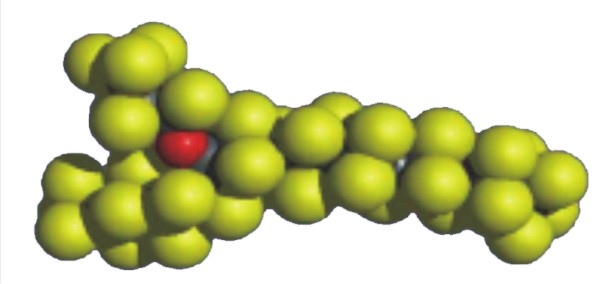 A space-filling molecular model with yellow spheres representing atoms and one red sphere, likely indicating a different element, against a white background.