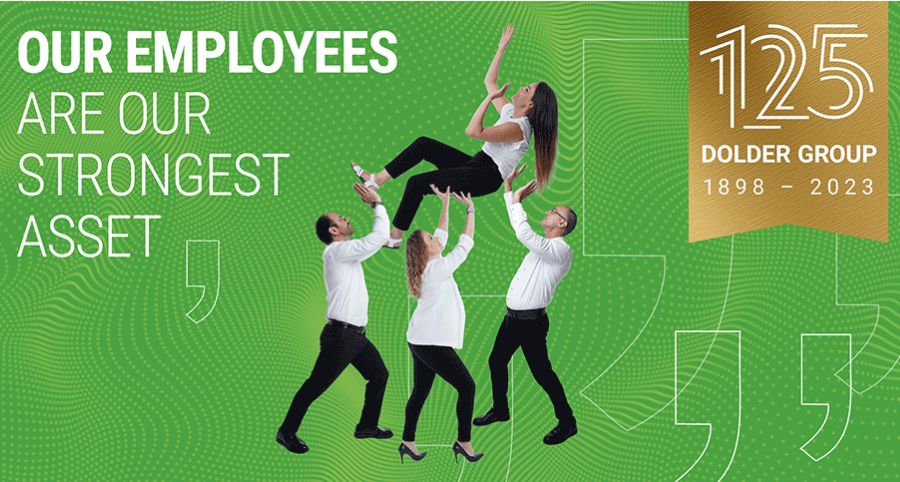 Four employees in business attire lift a female colleague on a green background with text reading "Our employees are our strongest asset" and a "125 Dolder Group 1898-2023" anniversary badge.